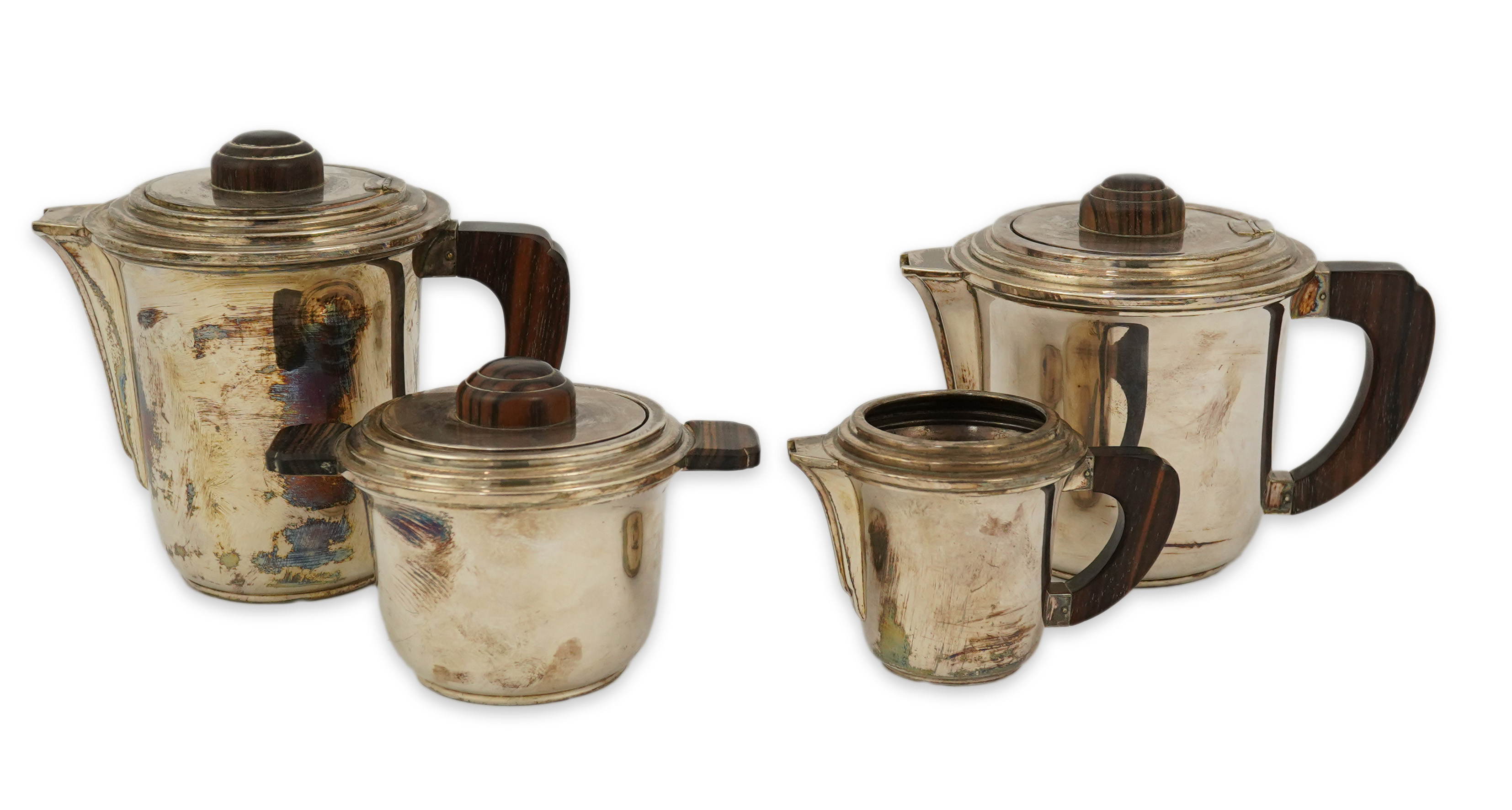 A stylish French Art Deco 950 standard silver and rosewood mounted four piece tea set